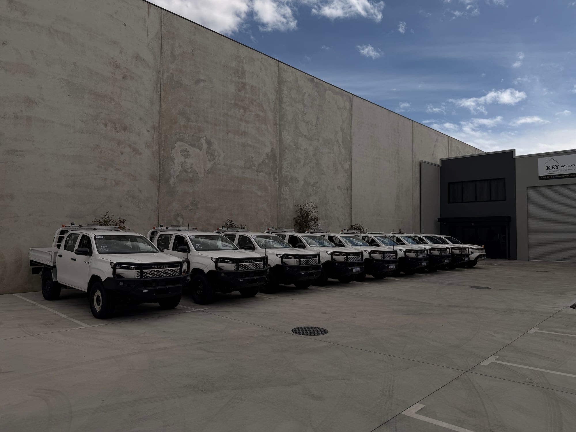 A full row of fitted out fleet utes lined up outside the RAEG workshop