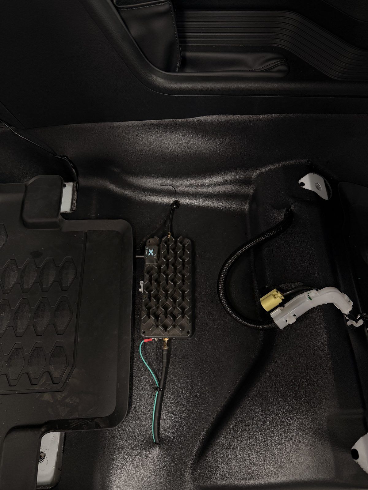 Cel-Fi mobile signal booster installed under the floor trim