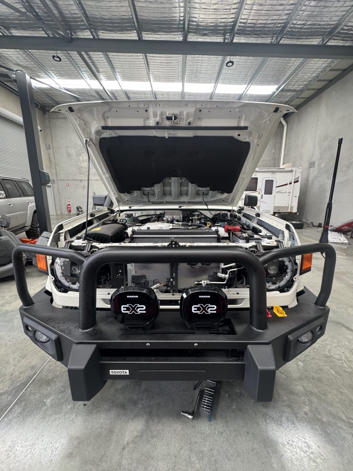 Narva EX2 driving lights being installed on a LandCruiser